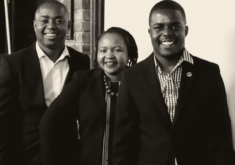 Three people standing together, photographed after a session.